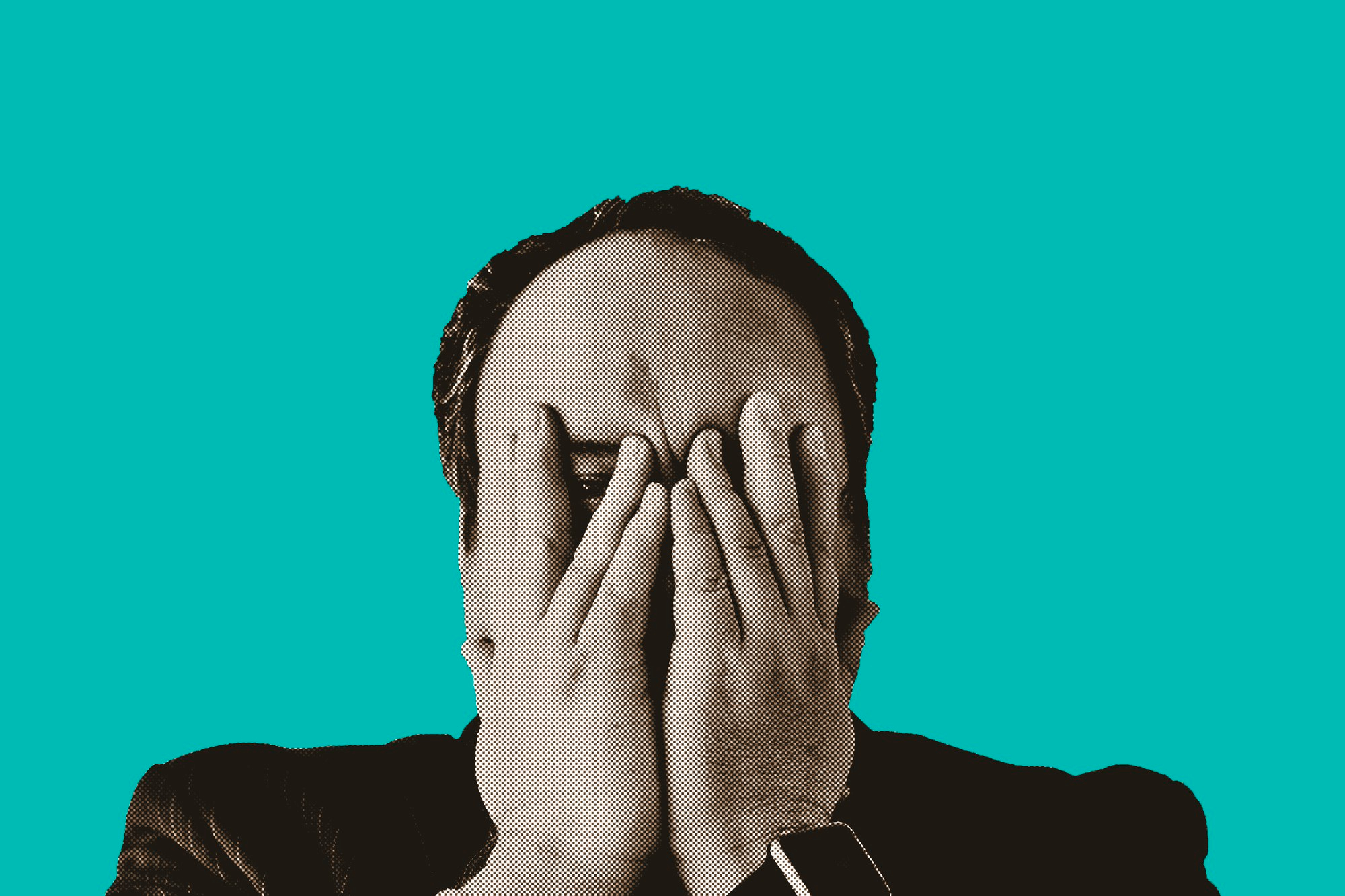 upset businessman with hands over face